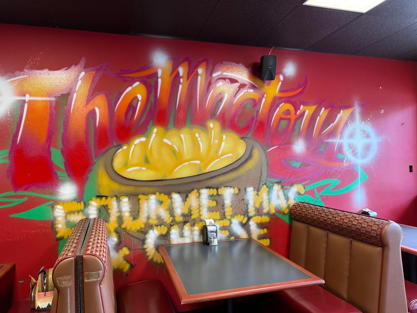 Inside The Mactory — graffiti mural and red booths